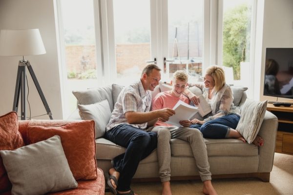 famiglia-felice-uarda-fogli-per-assicurazioni-viaggio-minori.